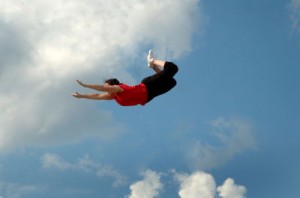 Woman jumpingfor trapeze